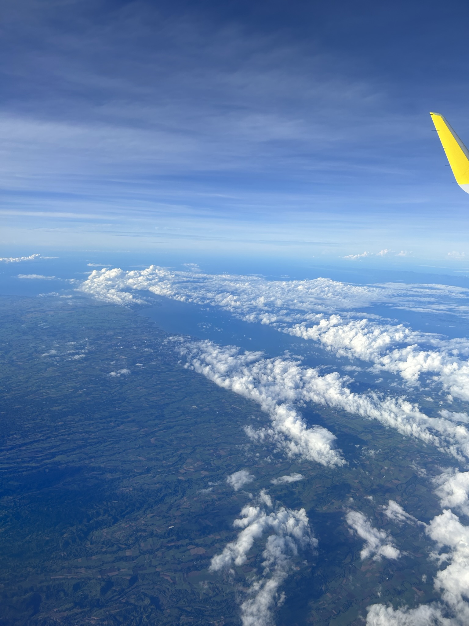 Picture of the clouds through the window in an airplane.